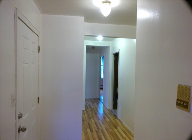 hallway with light hardwood / wood-style floors