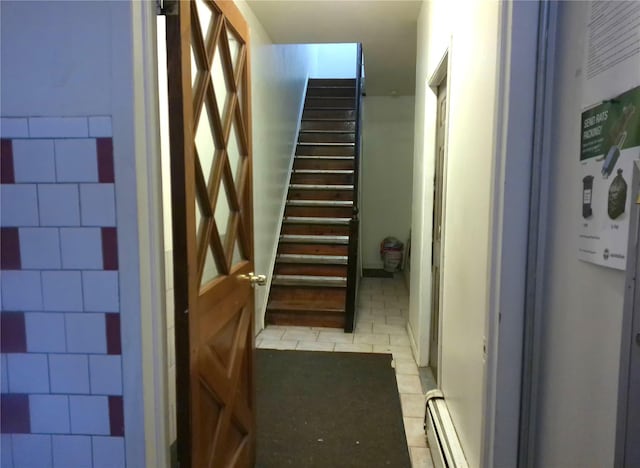 stairs featuring a baseboard heating unit