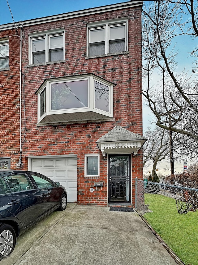 view of property featuring a garage and a front yard