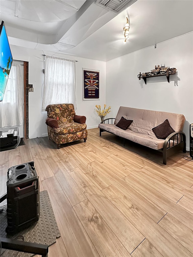 living room with plenty of natural light and light hardwood / wood-style flooring