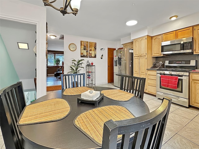 dining area with an inviting chandelier and light tile patterned floors