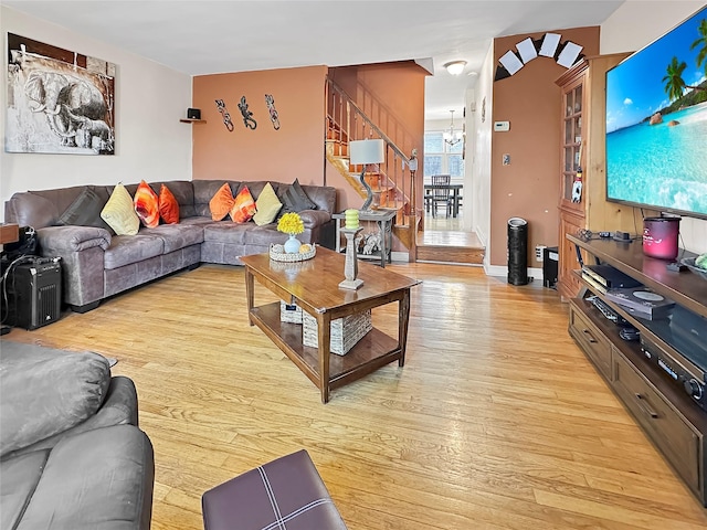 living room with a chandelier and light hardwood / wood-style flooring