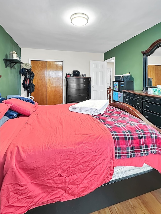 bedroom featuring hardwood / wood-style flooring and a closet