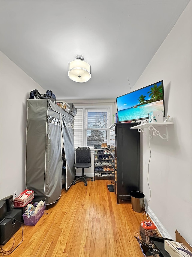 interior space with vaulted ceiling and hardwood / wood-style flooring