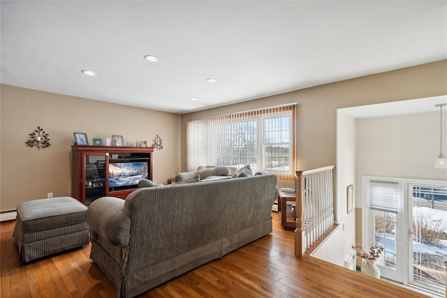 living room with hardwood / wood-style flooring and a baseboard radiator