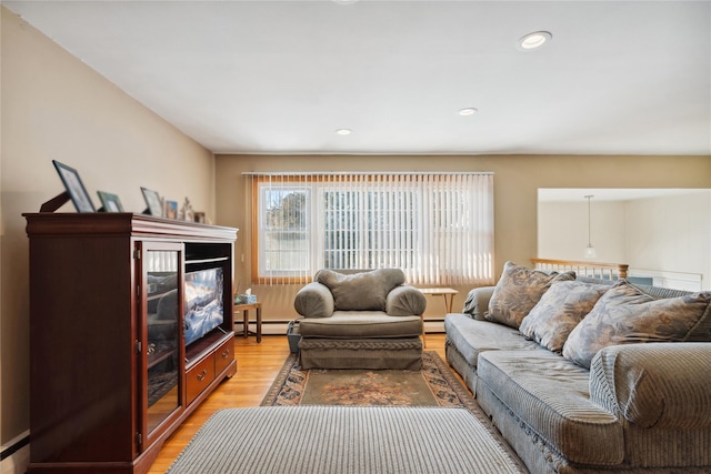 living room with hardwood / wood-style floors and a baseboard heating unit