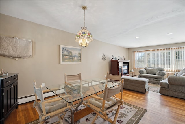 dining space with an inviting chandelier and light wood-type flooring