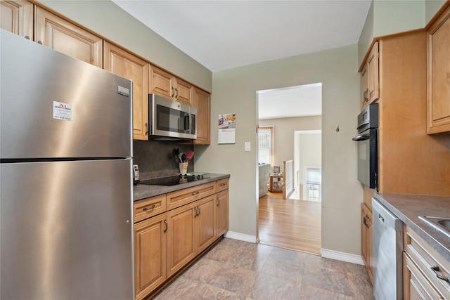 kitchen with tasteful backsplash and black appliances