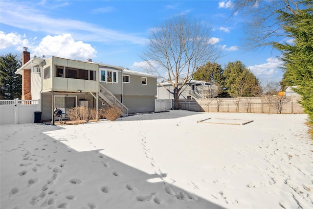 back of property with a sunroom