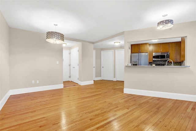 unfurnished living room featuring light wood-type flooring