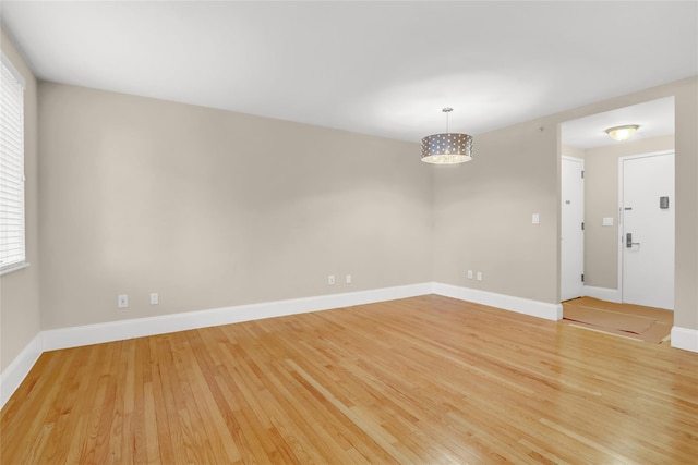 unfurnished room with a healthy amount of sunlight and light wood-type flooring