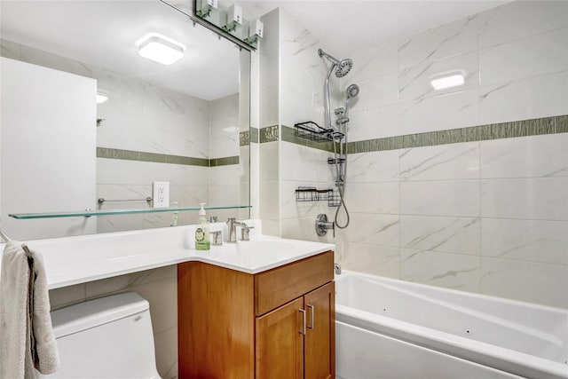 full bathroom featuring toilet, tiled shower / bath, and vanity