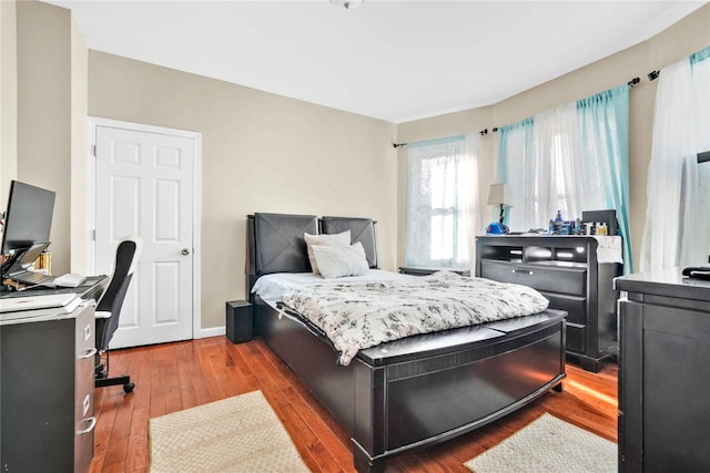 bedroom with dark hardwood / wood-style floors