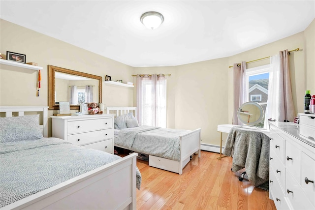 bedroom featuring light hardwood / wood-style floors and a baseboard radiator