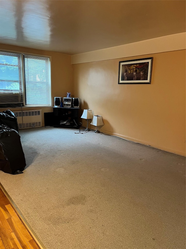 office area with radiator heating unit and carpet flooring