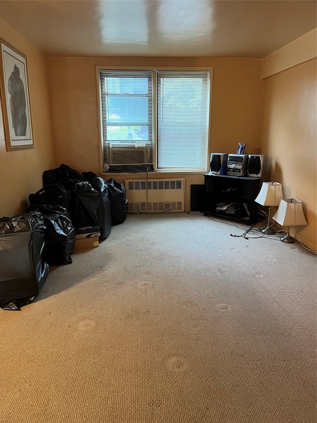 misc room with cooling unit, radiator heating unit, and carpet flooring