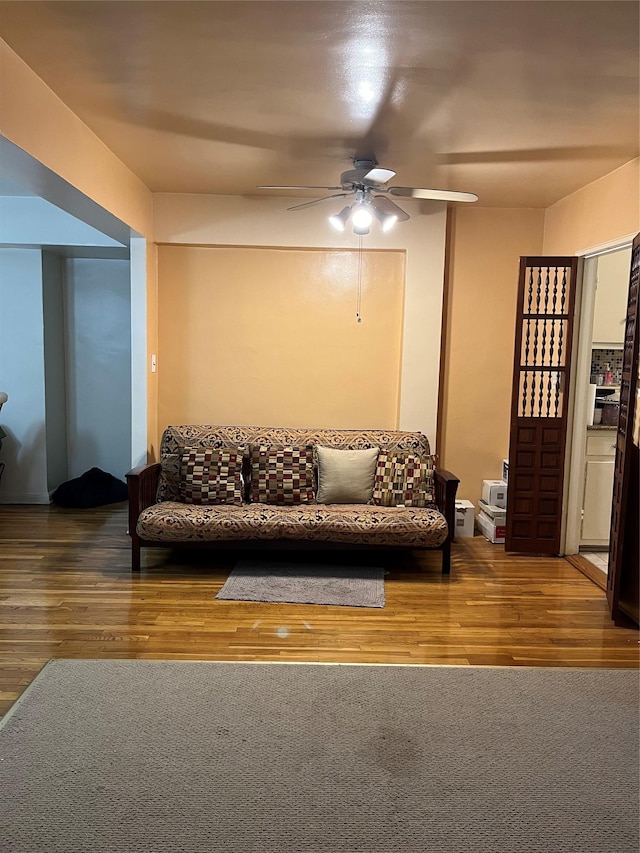 living room with ceiling fan and wood-type flooring