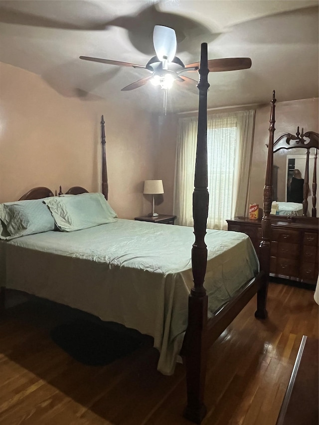 bedroom with ceiling fan and dark wood-type flooring