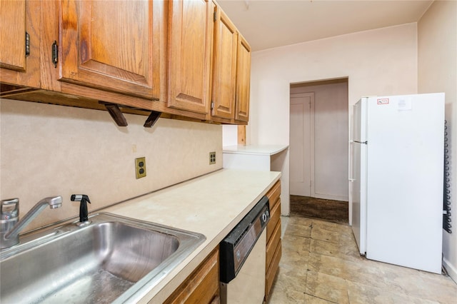 kitchen featuring sink, dishwasher, and white fridge