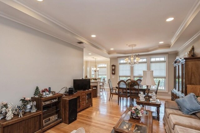 319 Trotting Ln Unit 23, Westbury, NY 11590 - living area featuring a chandelier, a tray ceiling, light wood-style flooring, recessed lighting, and crown molding