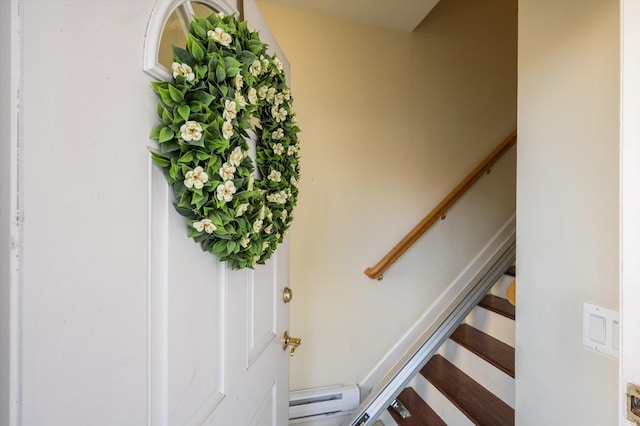 staircase featuring baseboard heating