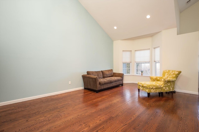 living area featuring dark hardwood / wood-style flooring and high vaulted ceiling