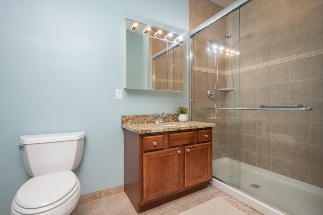 bathroom with a shower with door, tile patterned floors, toilet, and vanity