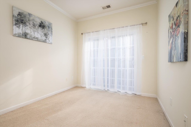 empty room featuring light colored carpet and crown molding