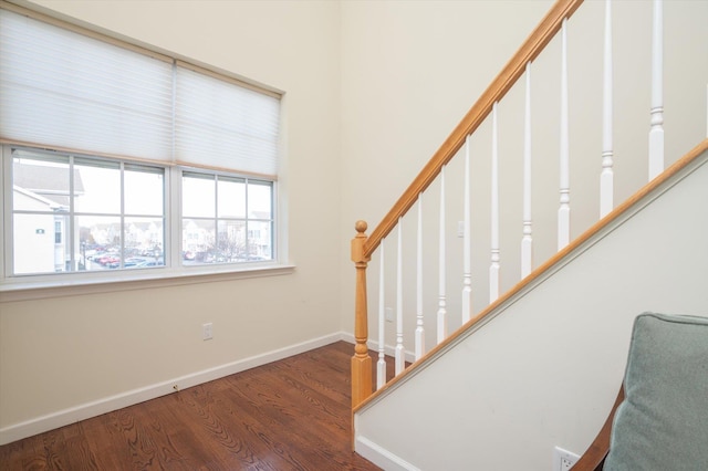 stairs featuring hardwood / wood-style floors