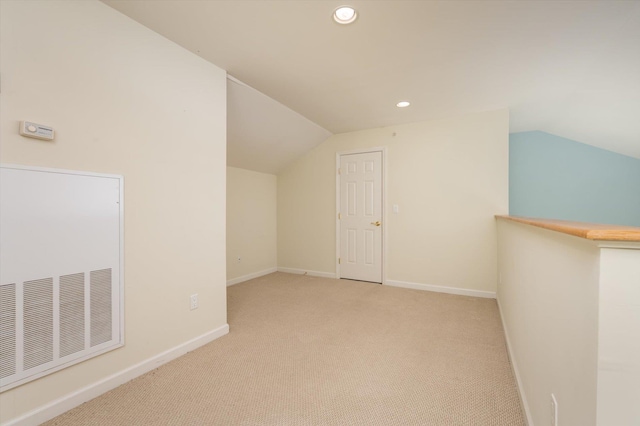 bonus room with light carpet and lofted ceiling