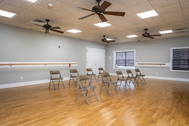 dining area featuring a paneled ceiling and light hardwood / wood-style floors