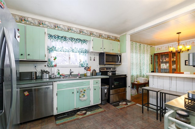 kitchen featuring appliances with stainless steel finishes, sink, backsplash, hanging light fixtures, and a chandelier