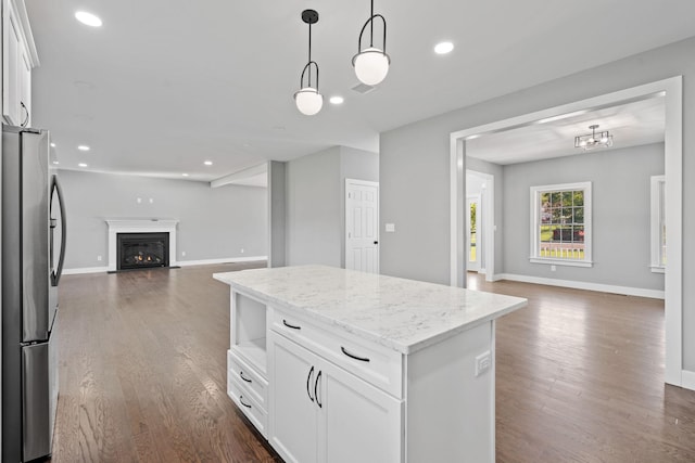 kitchen with white cabinets, open floor plan, dark wood-type flooring, and freestanding refrigerator