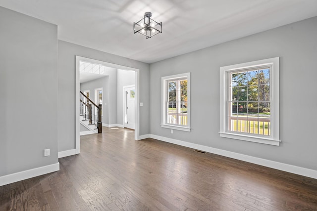 interior space featuring visible vents, dark wood finished floors, stairway, and baseboards