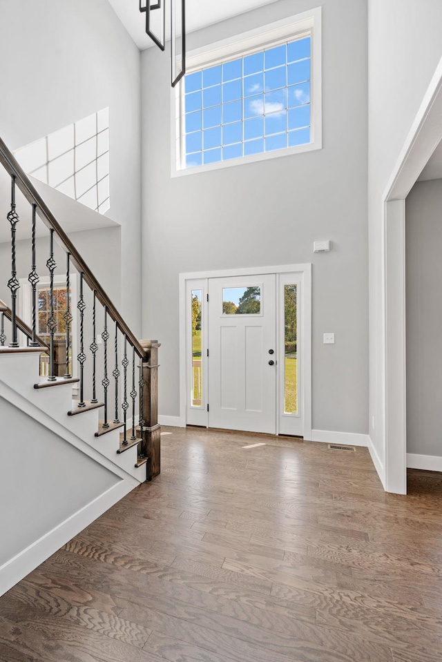 entryway featuring wood finished floors, a wealth of natural light, and baseboards