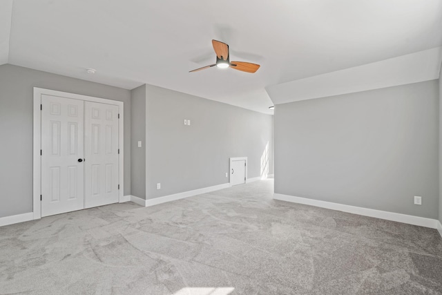 interior space featuring ceiling fan, carpet, and baseboards