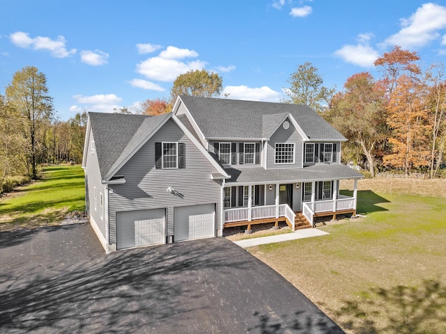 colonial inspired home featuring an attached garage, a porch, a front yard, and a shingled roof