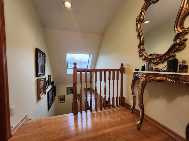 stairway featuring vaulted ceiling