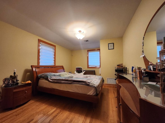 bedroom with hardwood / wood-style floors