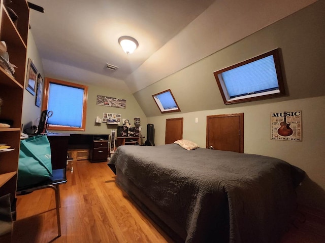 bedroom featuring hardwood / wood-style flooring and vaulted ceiling