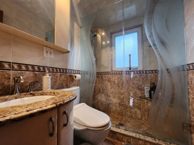 bathroom featuring vanity, a shower, backsplash, tile walls, and toilet