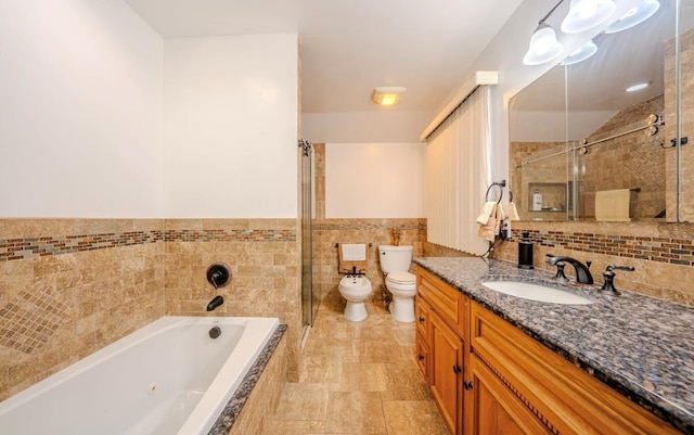 full bathroom with toilet, vanity, tile walls, separate shower and tub, and a bidet