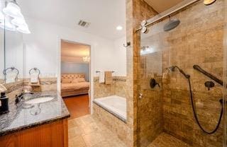 bathroom with vanity and a tile shower