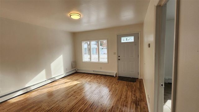 entrance foyer with a baseboard heating unit and hardwood / wood-style flooring