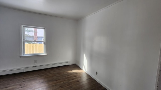 empty room featuring dark wood-type flooring and baseboard heating