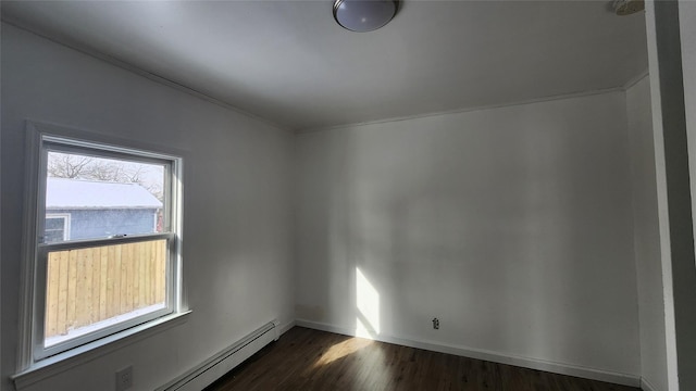 spare room with dark hardwood / wood-style floors and a baseboard radiator