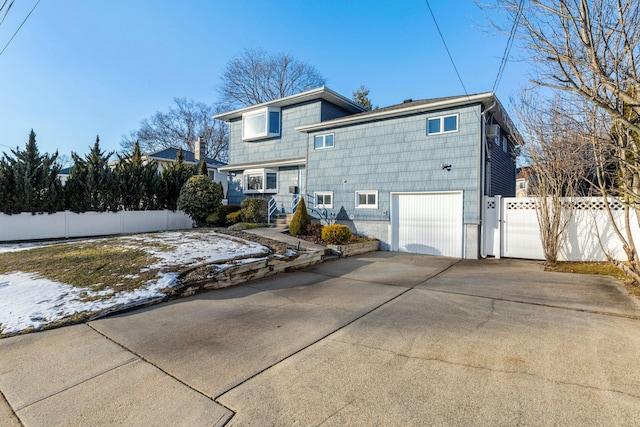 rear view of property featuring a garage