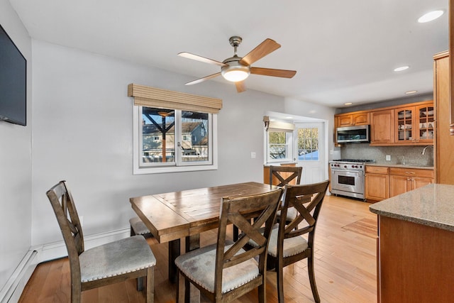 dining space featuring light wood finished floors, a ceiling fan, and recessed lighting