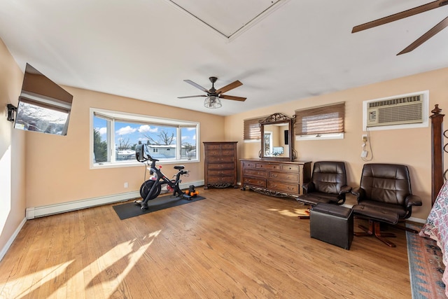 workout room featuring light wood-style floors, baseboards, a ceiling fan, and a wall mounted air conditioner