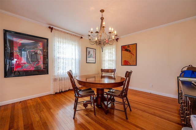 dining area with radiator, an inviting chandelier, crown molding, and light wood-type flooring